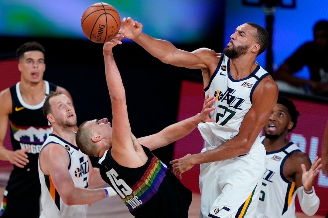 (Ashley Landis | AP) Utah Jazz's Rudy Gobert (27) blocks the shot of Denver Nuggets' Nikola Jokic (15) during the first half of an NBA basketball first round playoff game, Wednesday, Aug. 19, 2020, in Lake Buena Vista, Fla.