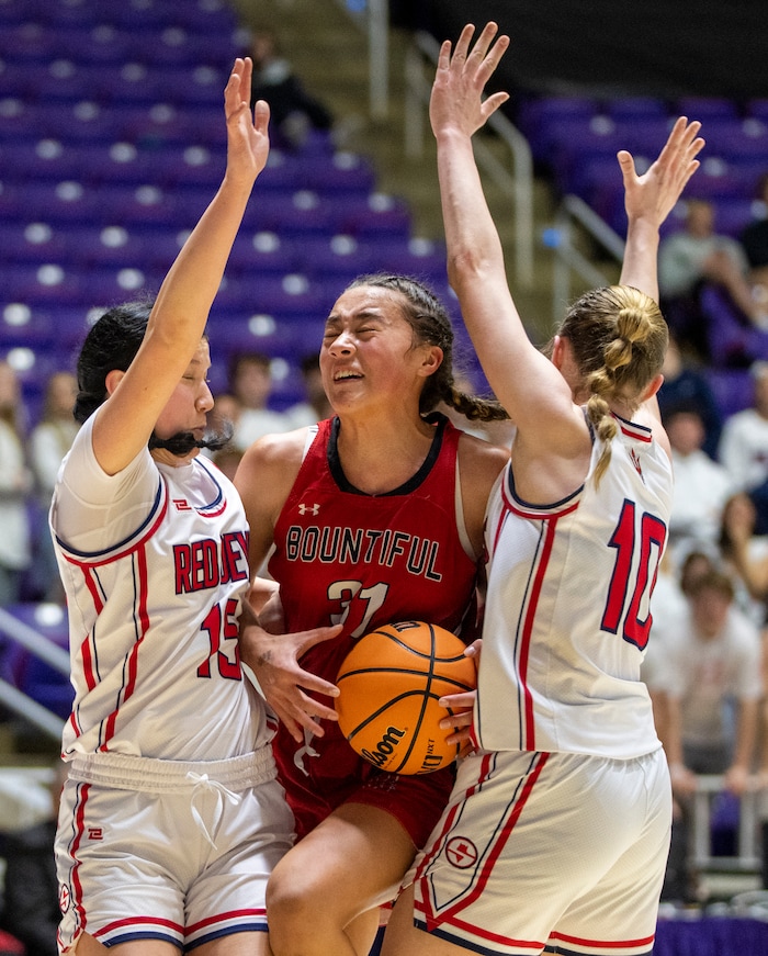 (Rick Egan | The Salt Lake Tribune) Bountiful Redhawks Milika Satuala, tries to split Springville Red Devil defenders Katie Durfey and Kayla  Porray, in the Girls 5A State Championship between the Springville Red Devils and the Bountiful Redhawks, at Weber State, on Saturday, March 4, 2023.

