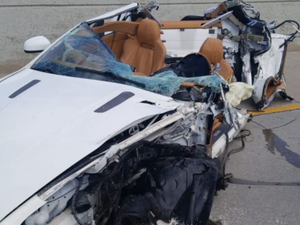 (Photo courtesy Utah Highway Patrol) A crashed Aston Martin sits on State Route 201 near 800 West on April 11. Troopers believe the driver was traveling over 100 mph when he hit a semi-truck, lost control and crashed. The 25-year-old driver was ejected from the car and died.