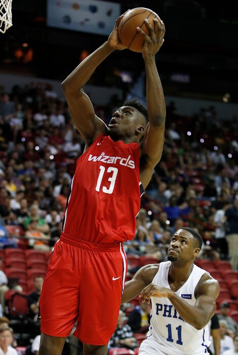 Washington Wizards' Thomas Bryant shoots over Philadelphia 76ers' Demetrius Jackson during the second half of an NBA summer league basketball game Monday, July 9, 2018, in Las Vegas. (AP Photo/John Locher)