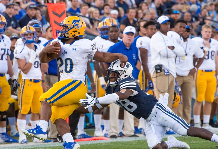 (Rick Egan  |  The Salt Lake Tribune)    Brigham Young Cougars defensive back Michael Shelton (18) brings down McNeese State Cowboys running back Justin Pratt (20), in football action Brigham Young Cougars vs McNeese State Cowboys at Lavell Edwards Stadium, Saturday, Sept. 22, 2018.


