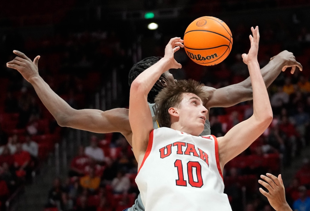 (Francisco Kjolseth  | The Salt Lake Tribune) Utah Utes forward Jake Wahlin (10) tries to regain control of the ball as Utah hosts West Virginia, NCAA basketball in Salt Lake City, Tuesday, March 4, 2025.