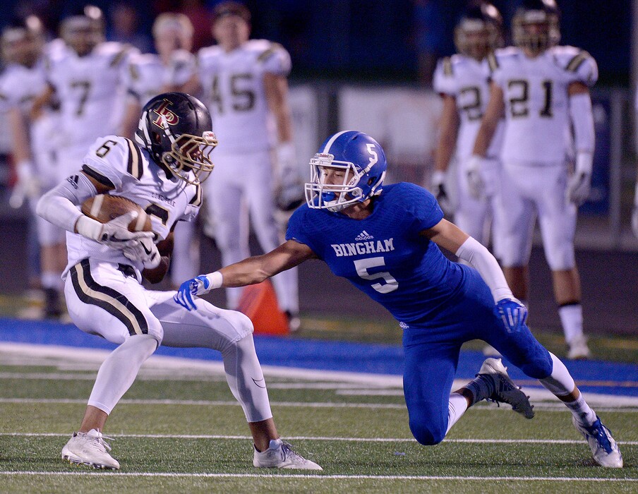 (Leah Hogsten  |  The Salt Lake Tribune) Bingham's Dax Milne misses the tackle on Lone Peak's Carson Stosich during their game Friday.