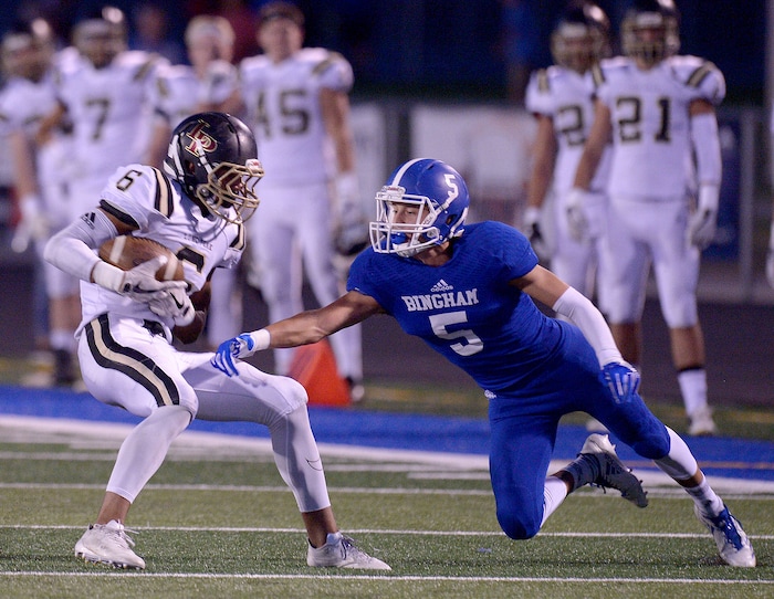 (Leah Hogsten | The Salt Lake Tribune) Bingham's Dax Milne misses the tackle on Lone Peak's Carson Stosich. Bingham High School leads Lone Peak High School, 14-3 during their game Friday, September 28, 2017 in South Jordan.