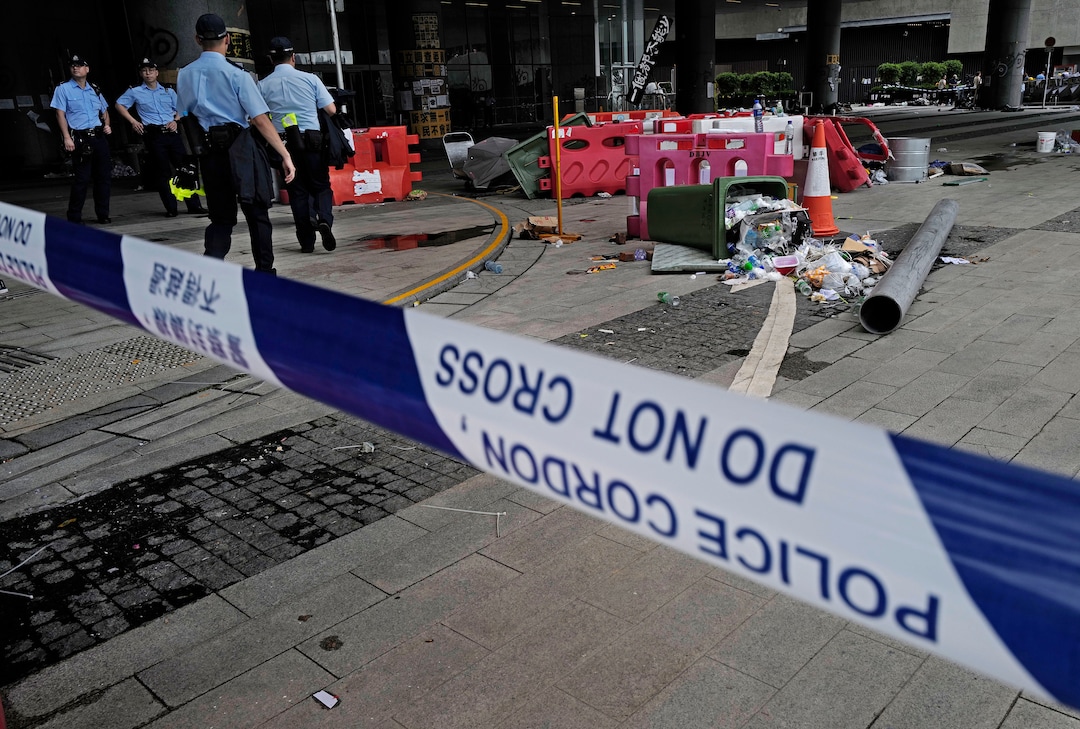 (Vincent Yu | AP Photo) Police officers stand guard outside Legislative Council building in Hong Kong, Tuesday, July 2, 2019. Hundreds of protesters swarmed into Hong Kong's legislature Monday night, defacing portraits of lawmakers and spray-painting pro-democracy slogans in the chamber before vacating it as riot police cleared surrounding streets with tear gas and then moved inside.