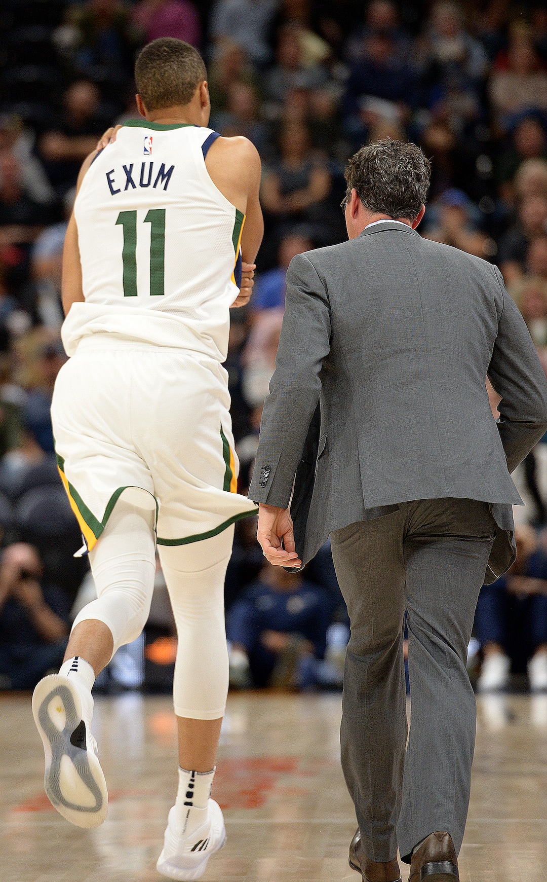 (Leah Hogsten  |  The Salt Lake Tribune) Utah Jazz guard Dante Exum (11) runs off the court holding his left shoulder after hitting the deck in the first half as the Utah Jazz host the Phoenix Suns during preseason NBA basketball at Vivint Smart Home Arena in Salt Lake City, October 6, 2017.