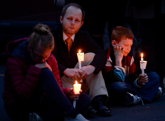 Leah Hogsten | The Salt Lake Tribune l-r Jennifer Frahm, husband Walker and son Atticus join their fellow community members outside Chabad Lubavitch of Utah as members of Utah's Jewish and interfaith communities hold a vigil and prayer service, Monday, Oct. 29, 2018 for the 11 people killed at the Tree of Life Synagogue in Pittsburgh.