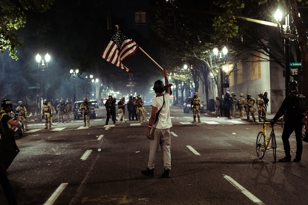 (Mason Trinca | New York Times file photo) Federal agents clash with protestors near the U.S. federal court building in Portland, Ore., July 22, 2020. "Trump is pretending that he is bringing law and order to chaotic streets, and now he has dispatched similar troops — what else can you call a militarized force like this but "troops"? — to Seattle, where that city's mayor has also said they are unwanted," writes New York Times columnist Nicholas Kristof.