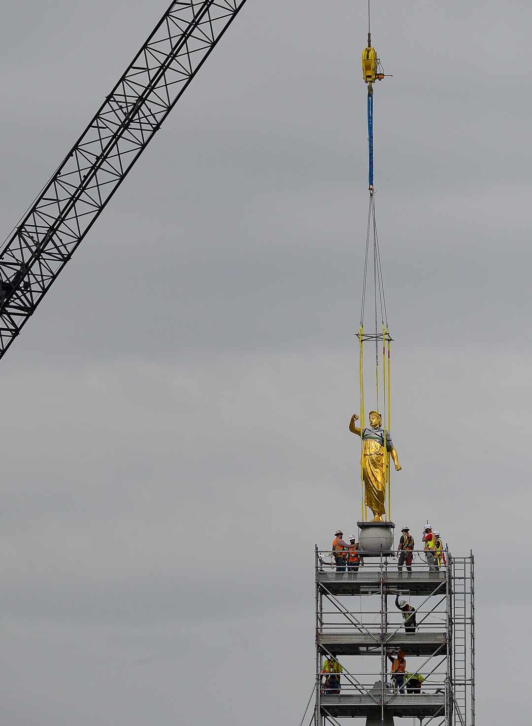 (Francisco Kjolseth  |  The Salt Lake Tribune) Crews work to remove the Angel Moroni statue atop the Salt Lake Temple of The Church of Jesus Christ of Latter-day Saints on Monday, May 18, 2020. The temple closed in December for seismic upgrades and sustained minor damager during the March 18, 2020, magnitude 5.7 earthquake when the trumpet held by the angel fell off and several smaller spire stones were displaced.