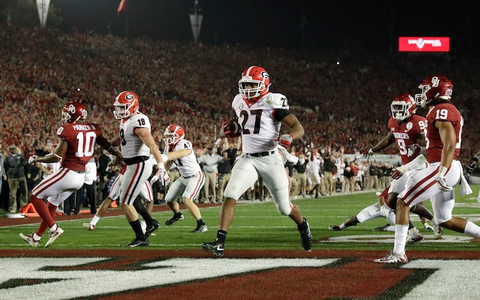 Georgia running back Nick Chubb (27) scores a touchdown against Oklahoma late in the second half of the Rose Bowl NCAA college football game, Monday, Jan. 1, 2018, in Pasadena, Calif. (AP Photo/Gregory Bull)