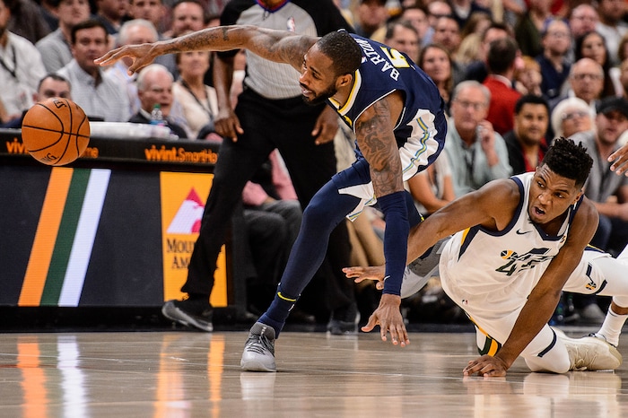 (Trent Nelson | The Salt Lake Tribune)  Denver Nuggets guard Will Barton (5) and Utah Jazz guard Donovan Mitchell (45) dive after a loose ball as the Utah Jazz host the Denver Nuggets, NBA basketball in Salt Lake City, Wednesday October 18, 2017.
