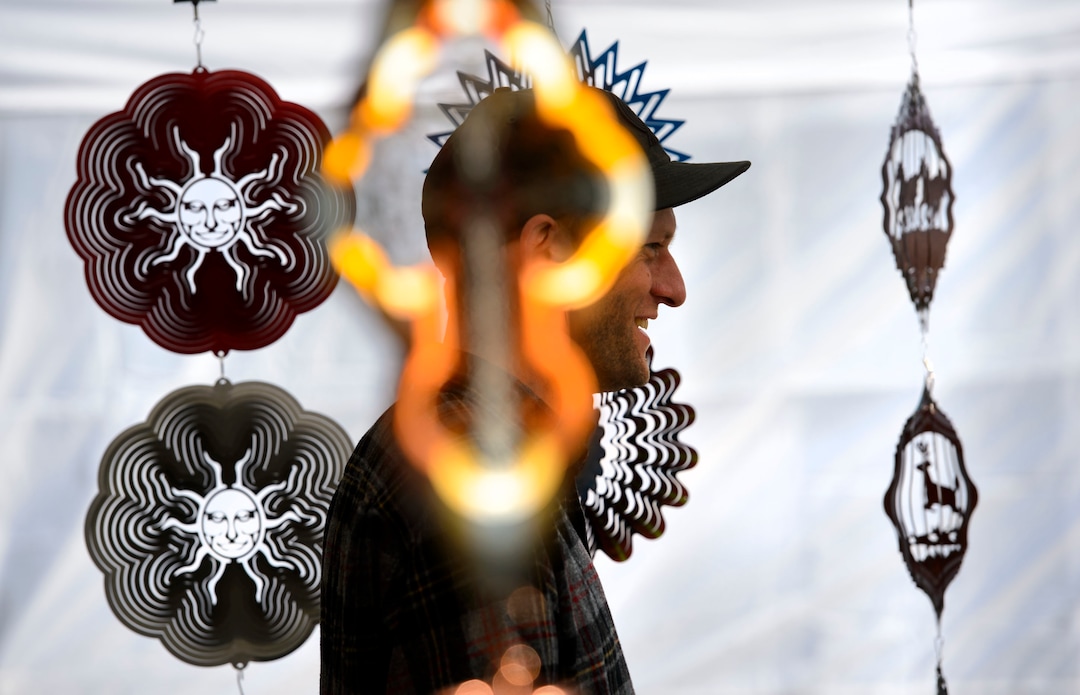 (Steve Griffin  |  The Salt Lake Tribune) Artist Jonathan Magee of the Oregon Wind Spinners talks with festival goers as his art flashes reflected light as they spin during the Urban Arts Festival at the Gallivan Center in Salt Lake City Sunday September 17, 2017. The two day festival featured artists, music, dance performance, automotive arts, projection art, virtual reality and new media arts.
