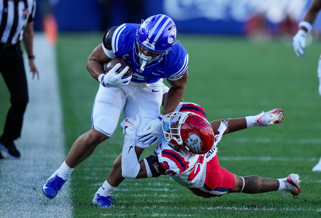 (Francisco Kjolseth | The Salt Lake Tribune)BYU Cougars running back Lj Martin (4) tries to stay inbound as he’s taken down by Utah Tech Trailblazers defensive back Ryan Tillman (20) during the first half of an NCAA college football game against Utah Tech, Saturday, Sept. 5, 2026, at LaVell Edwards Stadium in Provo.