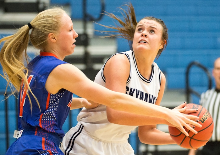 Rick Egan  |  The Salt Lake TribuneSalem Hills Skyhawks forward Lauren Gustin (12)is guarded by Timpview Thunderbirds Morgan Holbrook (14), in State Basketball Playoff action, The Salem Hills Skyhawks vs. The Timpview Thunderbirds, in Taylorsville, February 22, 2016.
