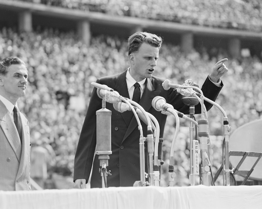 (AP Photo/Werner Kreusch, File) In this June 27, 1954, file photo, evangelist Billy Graham speaks to over 100,000 Berliners at the Olympic Stadium in Berlin, Germany.