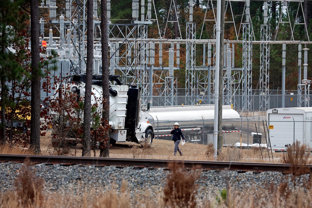 (Karl B DeBlaker | AP) Employees work on equipment at the West End Substation in West End, N.C., Monday, Dec. 5, 2022, where a serious attack on critical infrastructure has caused a power outage for many around Southern Pines, N.C. Utah's Rocky Mountain Power says it is working with law enforcement and industry to monitor Utah's grid security.