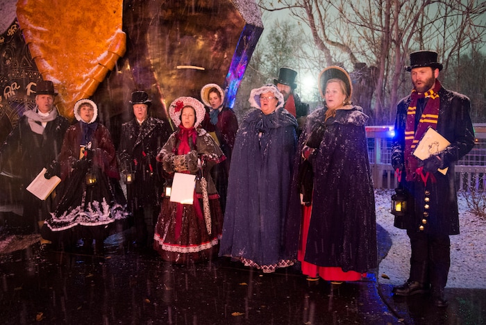 (Rick Egan  |  The Salt Lake Tribune)   A group of carolers sing as the ZooLights at Hogle Zoo are turned on, Friday, Nov. 30, 2018. The lights continue  through December 31st, 



