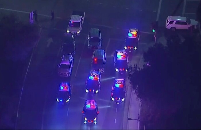 In this image made from aerial video, police vehicles block an intersection in the vicinity of a shooting in Thousand Oaks, California, early Thursday, Nov. 8, 2018.  Authorities say there were multiple injuries _ including one officer _ after a man opened fire in Southern California bar late Wednesday. (KABC via AP)