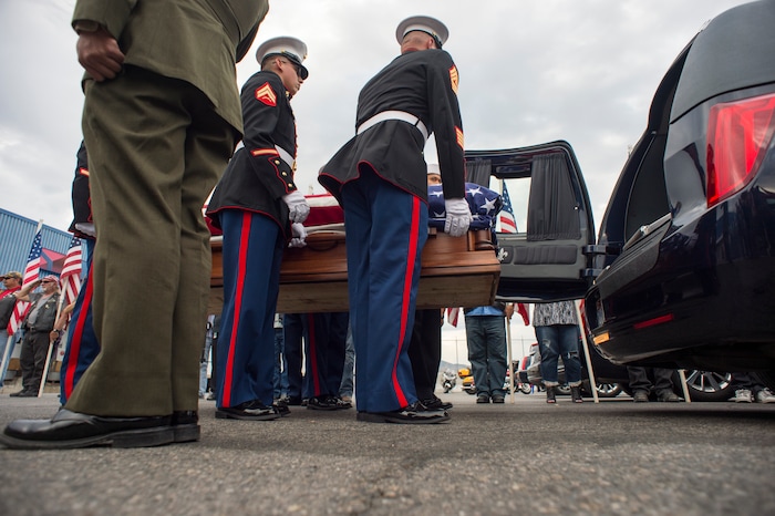 (Rick Egan  |  The Salt Lake Tribune)      The remains of Marine Pfc. Robert K. Holmes are carried from the Delta Air Cargo to a hearse for transportation to the mortuary.  Holmes died aboard the USS Oklahoma during the attack on Pearl Harbor. Friday, Aug. 17, 2018.