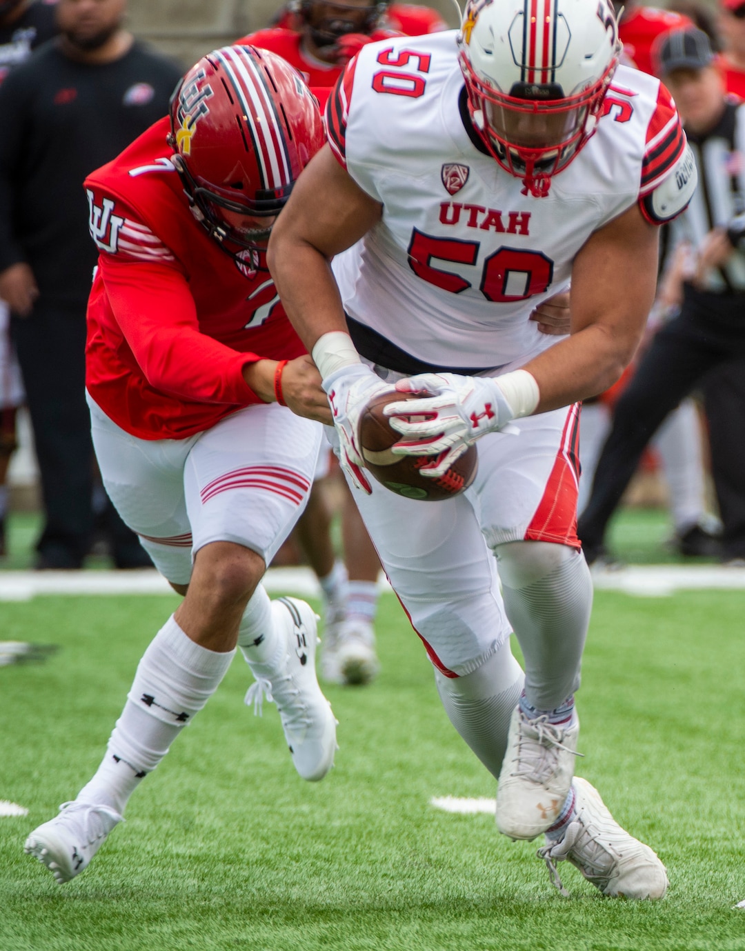 (Rick Egan  |  The Salt Lake Tribune)  Quarterback Cameraon Rising, (7) attempts to wrestle the ball back, after offensive lineman, Orlando Umana pickup his fumble, for a receiver, in Utah's spring Red-White game at Rice-Eccles Stadium, Saturday, April 13, 2019.