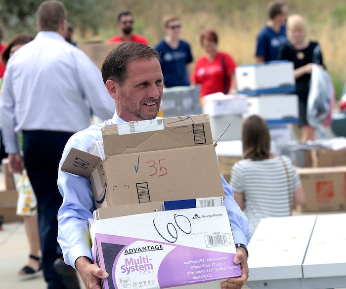 (Al Hartmann | The Salt Lake Tribune)
Rep. Chris Stewart unloads school supplies from his truck donated by citizens from his district for refugee students at Salt Lake Community College's Medowbrook campus in South Salt Lake Tuesday August 22. He later hosted a roundtable discussion with local refugees.