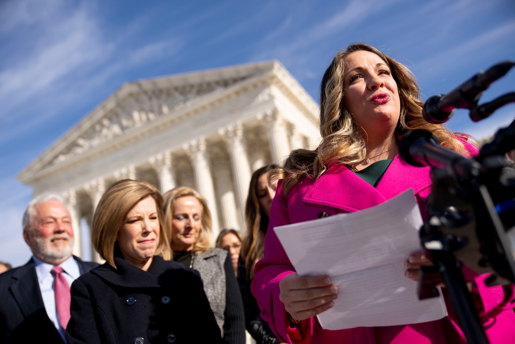 (Andrew Harnik | AP file photo) Lorie Smith, a Christian graphic artist and website designer in Colorado, right, accompanied by her lawyer, Kristen Waggoner of the Alliance Defending Freedom, second from left, speaks outside the Supreme Court in Washington, Monday, Dec. 5, 2022, after her case was heard before the Supreme Court.