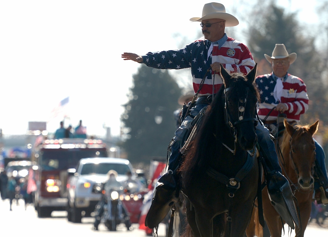 (Leah Hogsten  |  The Salt Lake Tribune)  Weber County Mounted Posse member Ed Valdez waves to the crowd at  Northern Utah’s 12th Annual Veterans Day Parade Saturday, Nov. 11, 2017 in Layton.