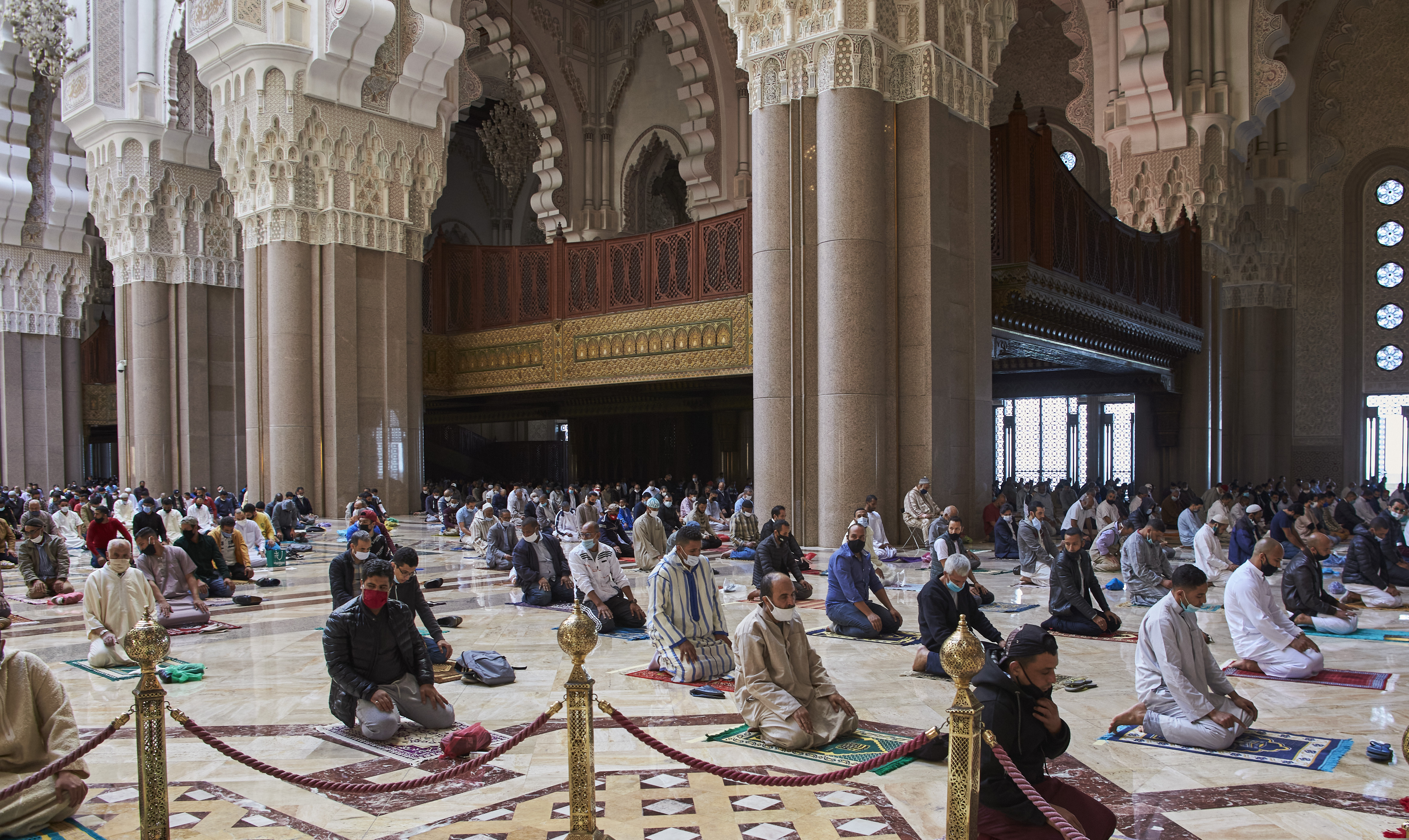 (Abdeljalil Bounhar | AP file photo)  Moroccans wear face masks and pray respecting social distancing at the great Hassan II Mosque in Casablanca, Morocco, Friday, Oct. 16, 2020.