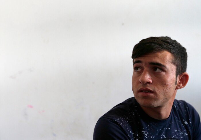 Hamad Ahmadi from Afghanistan speaks during an interview in the "Krnjaca" centre for asylum seekers near Belgrade, Serbia, Monday, Sept. 18, 2017. The European Union border that saw hundreds of thousands of migrants enter freely in 2015 has since become a sealed fortress with two rows of fence and closed border camps that the United Nations have described as “in effect detention centers.” (AP Photo/Darko Vojinovic)