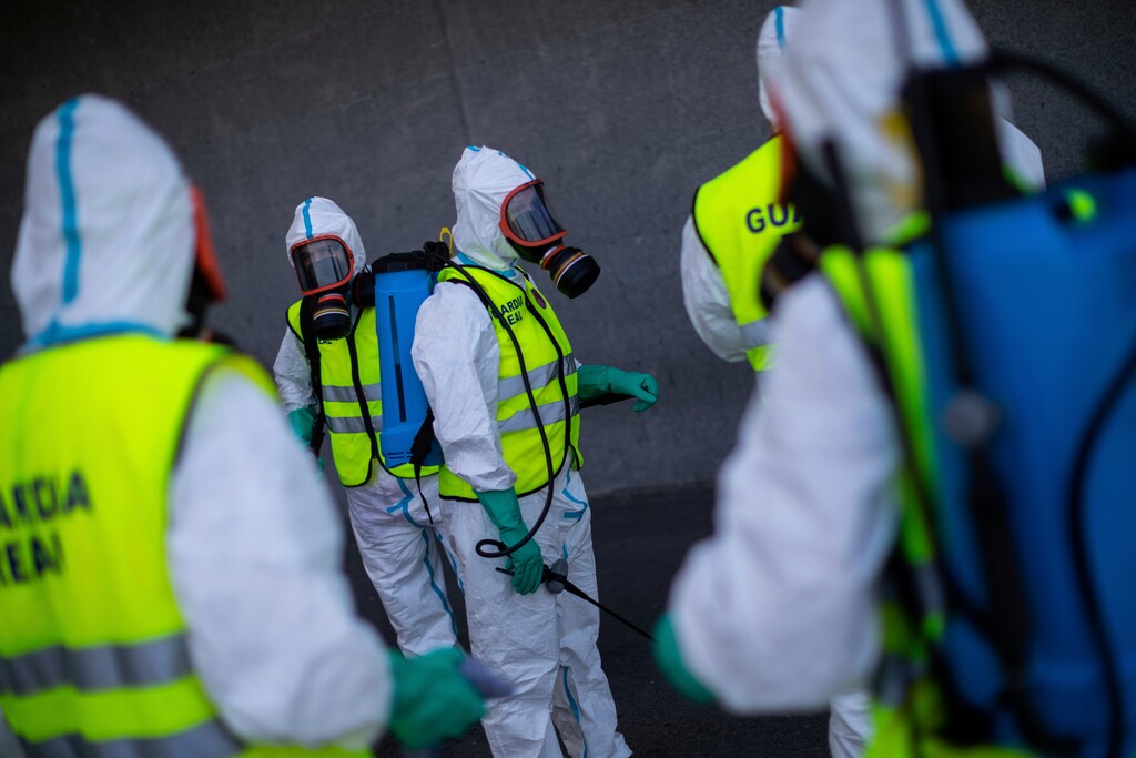(Bernat Armangue | AP) Spanish Royal guard soldiers disinfect a hospital to prevent the spread of the new coronavirus in Madrid, Spain, Sunday, March 29, 2020. Spain and Italy demanded more European help as they fight still-surging coronavirus infections amid the continent's worst crisis since World War II. The new coronavirus causes mild or moderate symptoms for most people, but for some, especially older adults and people with existing health problems, it can cause more severe illness or death.