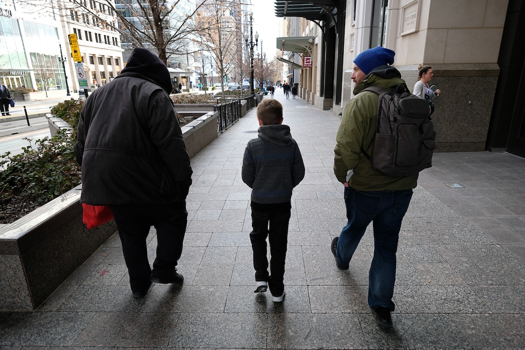 (Francisco Kjolseth  |  The Salt Lake Tribune) Ten-year-old Chase Hansen and his father John walk with Viliami Taufalele, left, after approaching him in downtown Salt Lake City and offer to buy him a meal in exchange for a little conversation on Monday, Dec. 16, 2019. Chase started an organization at the age of 6 called Project Empathy. The two of them spend time with people experiencing homelessness in an effort to connect with people on a personal level.
