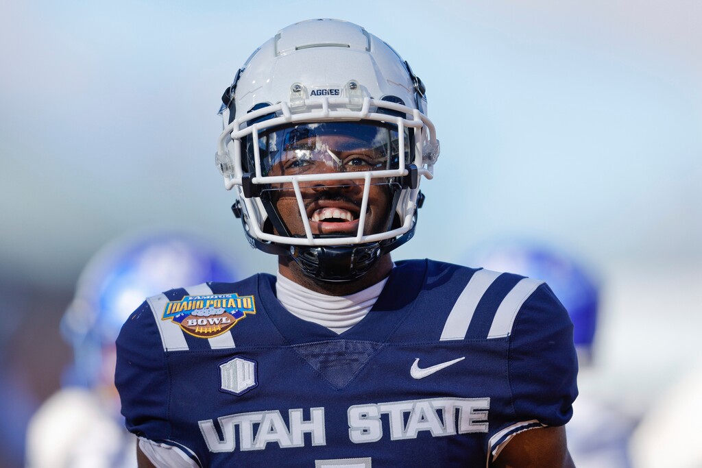 (Steve Conner | AP) Utah State wide receiver Jalen Royals (1) celebrates after a 35-yard touchdown reception against Georgia State in the first half of the Famous Idaho Potato Bowl NCAA college football game, Saturday, Dec. 23, 2023, in Boise, Idaho.