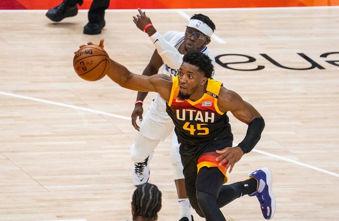 (Rick Egan | The Salt Lake Tribune) Utah  guard Donovan Mitchell (45) powers past LA Clippers guard Reggie Jackson (1) to score for the Jazz, in second round playoff action in game 2 between the Utah Jazz and the LA Clippers, at Vivint Arena, on Thursday, June 10, 2021.