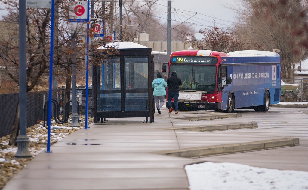 (Bethany Baker  |  The Salt Lake Tribune) Passengers prepare to board a UTA bus at Meadowbrook Station in South Salt Lake in 2024.