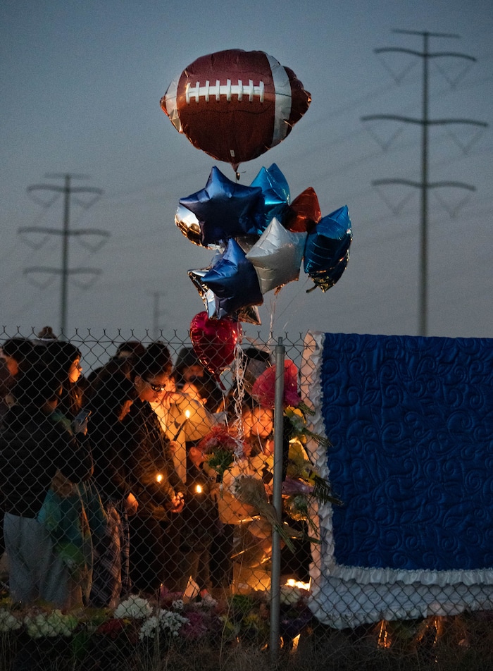 (Francisco Kjolseth | The Salt Lake Tribune) More that a hundred people gather at the candlelight vigil of Hunter High football players Paul Tahi , 15, Tivani Lopati, 14, and Ephraim Asiata, 15, on Friday, Jan 14, 2022, in West Valley City, near Hunter High School along 1400 South at Mountain View Corridor. Paul Tahi and Tivani Lopati were killed in a shooting, while Ephraim Asiata remains in critical condition.