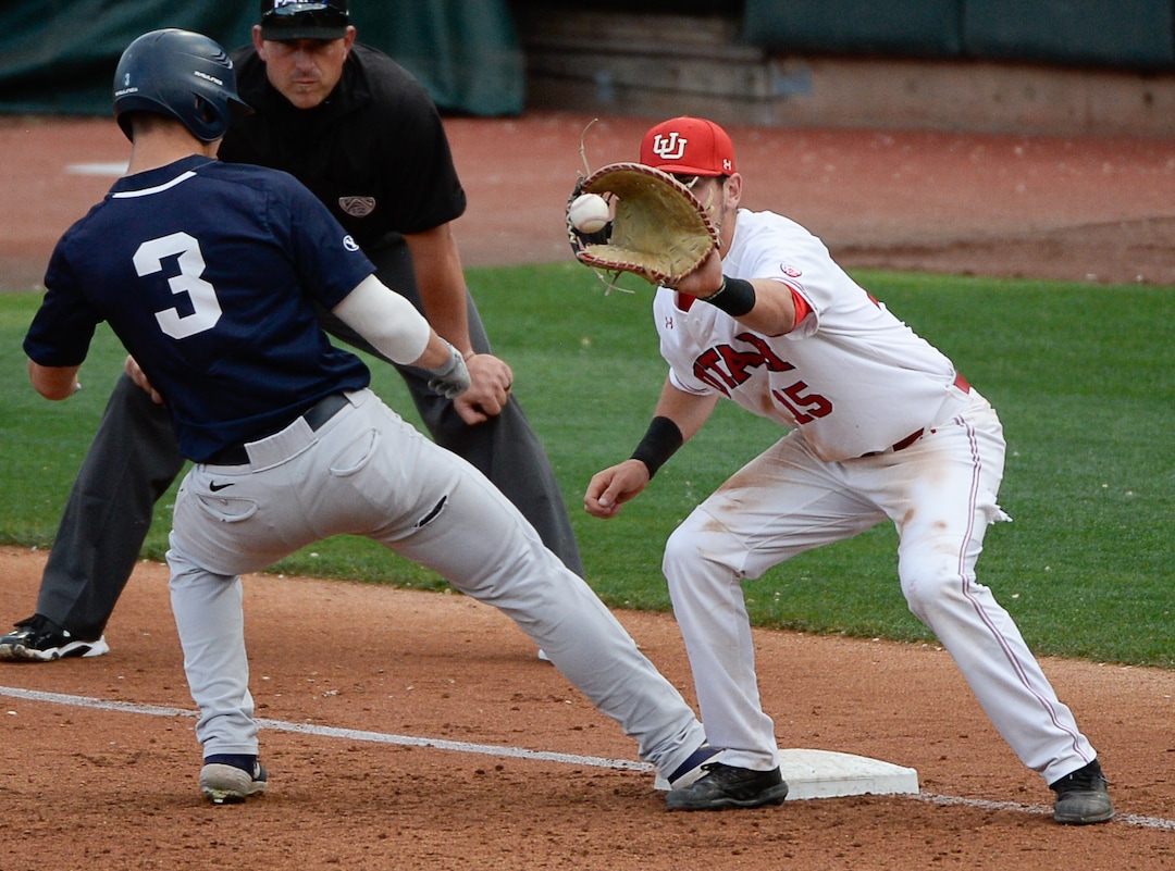 (Francisco Kjolseth  |  The Salt Lake Tribune)  Danny Gelalich steps back to first base just ahead of the ball being brought in by Shea Kramer as Utah and BYU renew their rivalry on the baseball diamond as they battle it out at Smith's Ballpark in Salt Lake City on Tuesday, May 14, 2019.