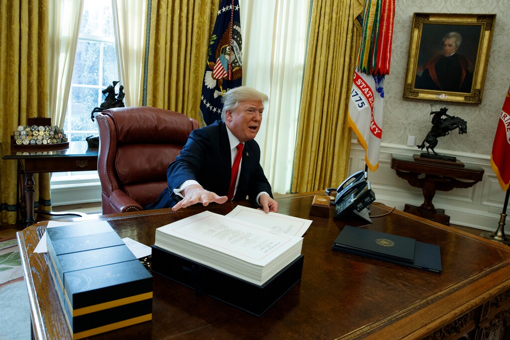 President Donald Trump speaks to reporters before signing the tax bill in the Oval Office of the White House, Friday, Dec. 22, 2017, in Washington. (AP Photo/Evan Vucci)