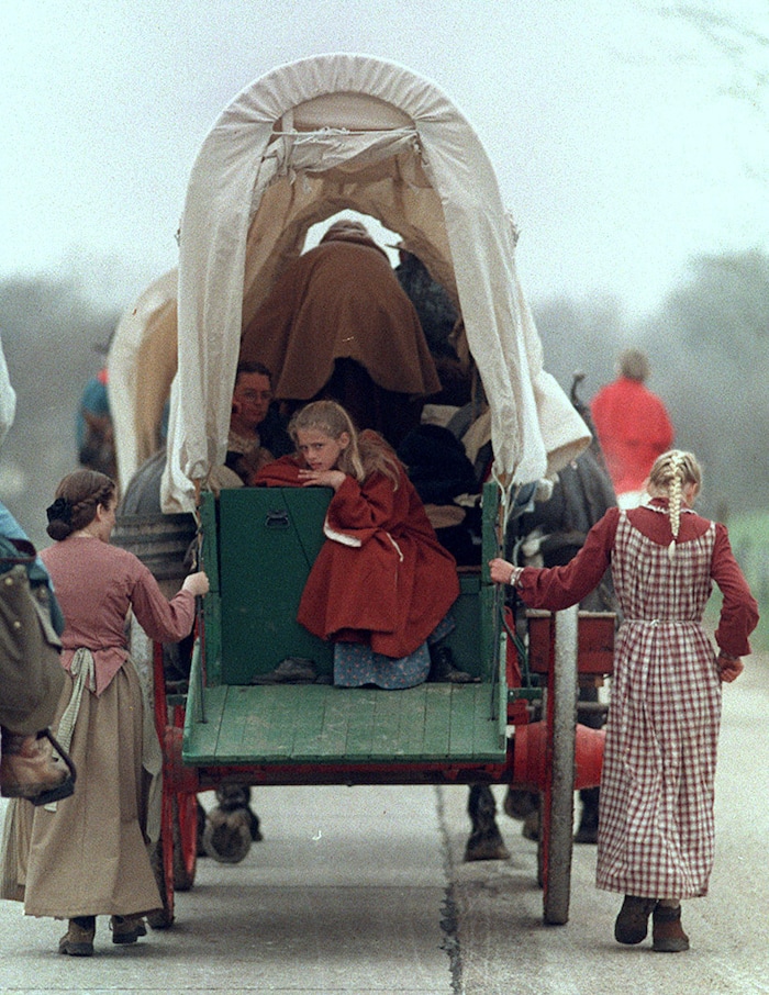 Rick Egan  | Tribune File Photo 

Christina Dicken, 11, Plymouth Washington, takes a rest by riding inside the wagon on the first day of the trek, outside of Omaha Nebraska.  
