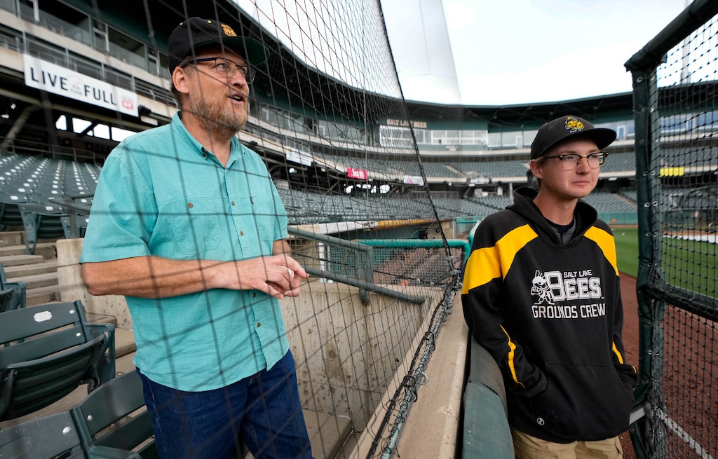 (Francisco Kjolseth | The Salt Lake Tribune) Jon Bray and his son Sam, 19, talk before a recent game between the Salt Lake Bees and the Albuquerque Isotopes on Tuesday, May 17, 2022. Through attending thousands of Triple-A, spring training and rookie league games, they have somehow done what most fans can only dream of: maneuver their way into the exclusive society of MLB.
