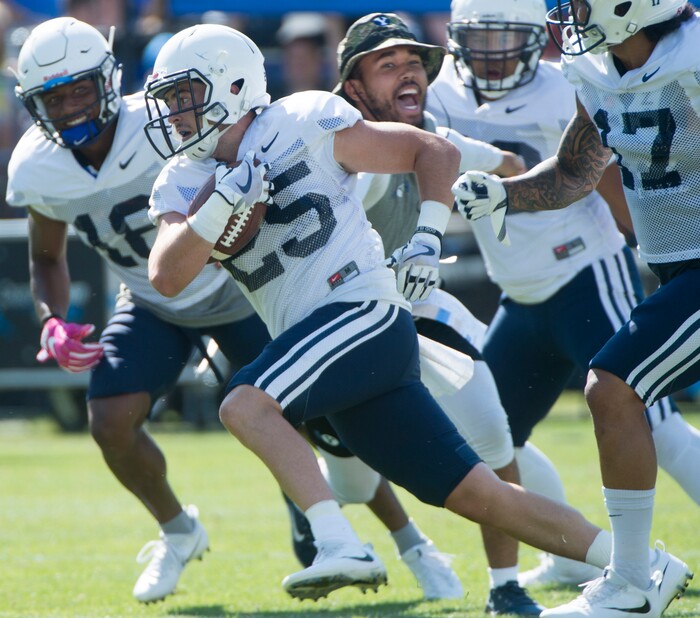 (Rick Egan  |  The Salt Lake Tribune)  	Defensiveback, Tanner Jacobson, runs with the ball, during the BYU scrimmage at Lavell Edwards Stadium, Thursday, August 17, 2017.