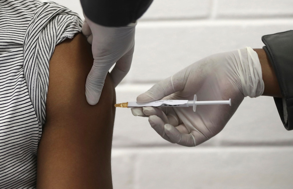 (Siphiwe Sibeko | AP) In this Wednesday, June 24, 2020 file photo, a volunteer receives an injection at the Chris Hani Baragwanath hospital in Soweto, Johannesburg, as part of Africa's first participation in a COVID-19 vaccine trial developed at the University of Oxford in Britain in conjunction with the pharmaceutical company AstraZeneca. On Friday, Oct. 23, 2020, AstraZeneca Inc. announced that the Food and Drug Administration is letting it resume testing of its COVID-19 vaccine candidate in the U.S.
