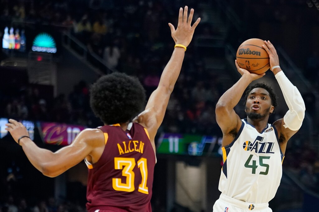 (Tony Dejak | AP) Utah Jazz's Donovan Mitchell (45) shoots over Cleveland Cavaliers' Jarrett Allen (31) in the first half of an NBA basketball game, Sunday in Cleveland.