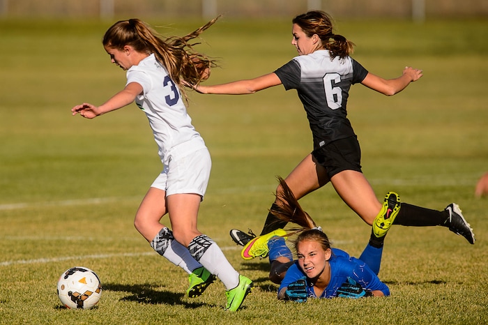 (Trent Nelson | The Salt Lake Tribune) Syracuse's Caroline Stringfellow (35) dribbles past Pleasant Grove goalkeeper Evie Brimhall for an easy goal in the Class 6A girls' soccer state quarterfinal between Pleasant Grove and Syracuse, in Syracuse Thursday October 12, 2017.