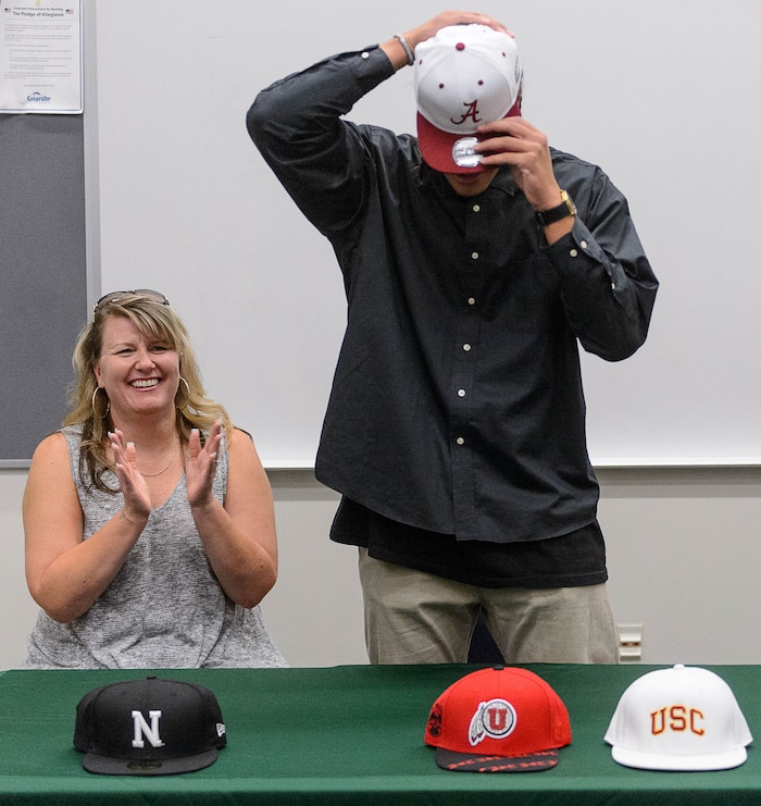 (Trent Nelson  |  The Salt Lake Tribune)  Olympus tight end Cameron Latu announces he's headed to Alabama during a news conference at Olympus High School in Salt Lake City Friday August 4, 2017. His mother Jill Argust is at left.