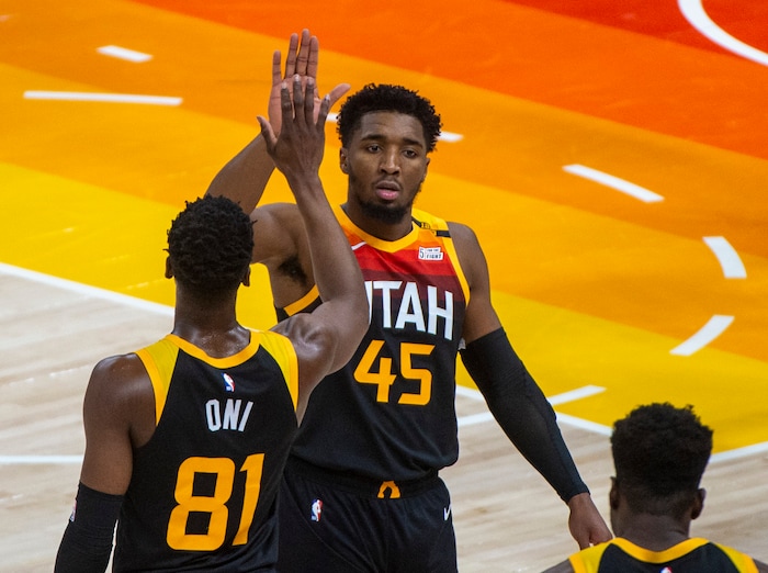 (Rick Egan | The Salt Lake Tribune) Utah Jazz guard Donovan Mitchell (45) gets a high-five from Utah Jazz guard Miye Oni (81) as he leaves the game part way through the 4th quarter with 26 points, in NBA action between the Utah Jazz and the Atlanta Hawks at Vivint Arena, on Friday, Jan. 15, 2021.