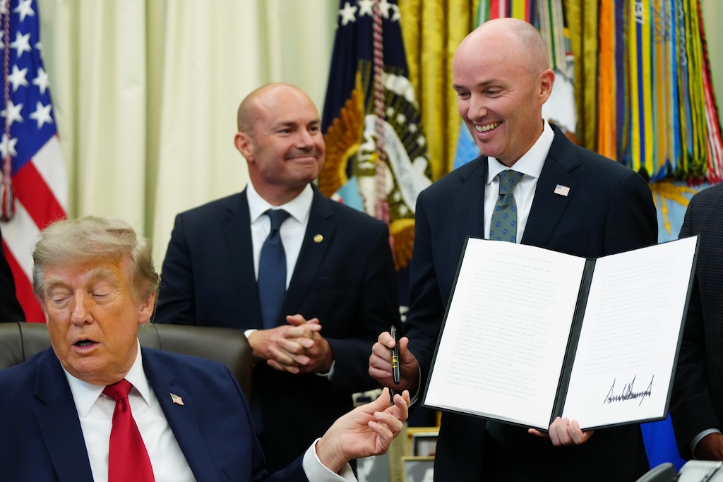 (Julia Demaree Nikhinson | AP) President Donald Trump hands a pen to Utah Gov. Spencer Cox after signing executive orders modifying the Grand Staircase-Escalante National Monument and the Bears Ears National Monument in the Oval Office of the White House, Monday, July 13, 2026, in Washington.