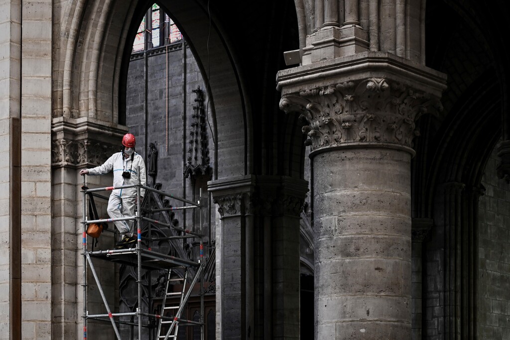 (Philippe Lopez | AP file photo) A worker stands on scaffolding during preliminary work inside the Notre Dame de Paris Cathedral, in Paris on May 15, 2019. The billionaire French donors that publicly promised flashy donations totaling hundreds of millions to restore Notre Dame, have not yet paid a penny toward the restoration of the French national monument, according to church and business officials. Instead, it's mainly American citizens that have footed the bills and paid salaries for the up to 150 workers employed by the cathedral since the April 15 fire.