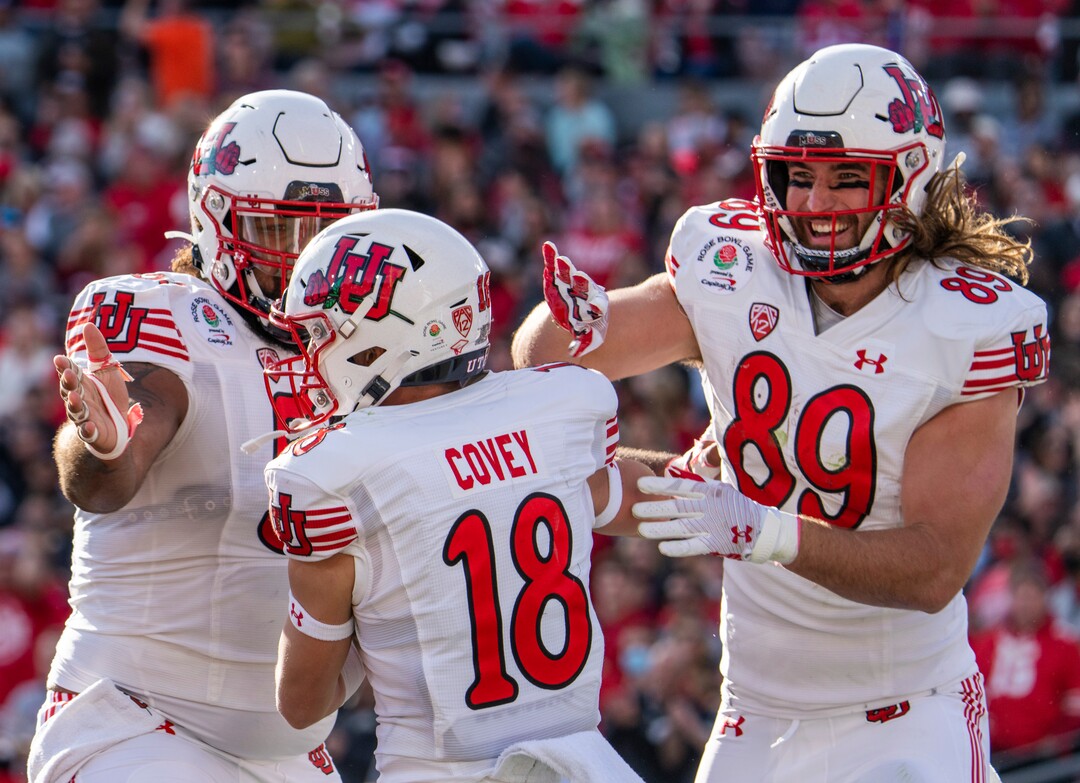 (Rick Egan | The Salt Lake Tribune)   Utah Utes offensive lineman Nick Ford (55) and tight end Cole Fotheringham (89) celebrate with Utah wide receiver Britain Covey (18) after he scored the first touchdown for the Utes, in the action, between Utah Utes and Ohio State Buckeyes in the Rose Bowl in Pasadena, on Saturday, January 1, 2022.