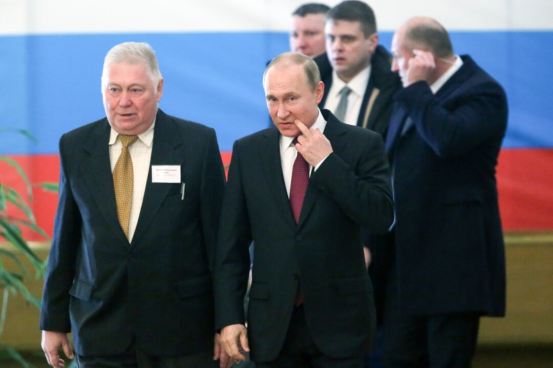 Russian President and Presidential candidate Vladimir Putin, foreground right, arrives to vote at a polling station during Russia's presidential election in Moscow, Russia, Sunday, March 18, 2018. Putin's victory in Russia's presidential election Sunday isn't in doubt. The only real question is whether voters will turn out in big enough numbers to hand him a convincing mandate for his fourth term — and many Russian workers are facing intense pressure to do so. (Sergei Chrikov/Pool Photo via AP)