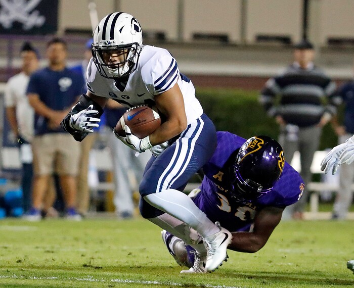 BYU's KJ Hall (24) tries to break away from East Carolina's Bruce Bivens (38) during the first half of an NCAA college football game in Greenville, N.C., Saturday, Oct. 21, 2017. (AP Photo/Karl B DeBlaker)